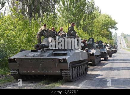 Service members of pro-Russian troops are seen atop of armoured vehicles during Ukraine-Russia conflict outside Donetsk, Ukraine May 13, 2022. REUTERS/Alexander Ermochenko