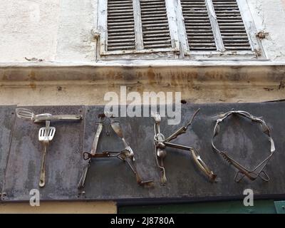 restaurant sign made with twisted silver wares in paris, france Stock Photo