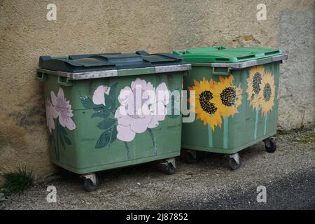 colorful flowers painted garbage cans in the street in ffrance Stock Photo