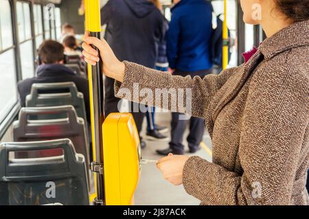 Young woman hand inserts the bus ticket into the validator, validating and ticking in Prague sity Chezh Stock Photo