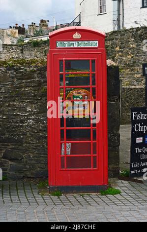 CONWY; CONWY COUNTY; WALES; 10-16-21. The Harbour on the River Conwy with an old red telephone box converted into a defibrillator point with the legal Stock Photo