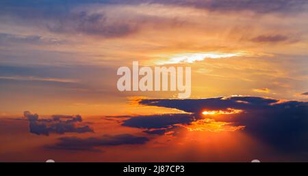 Beautiful dark orange sky evening beauty and Clouds at sunset , dawn, the rays of the sun break through the clouds. Natural Stock Photo