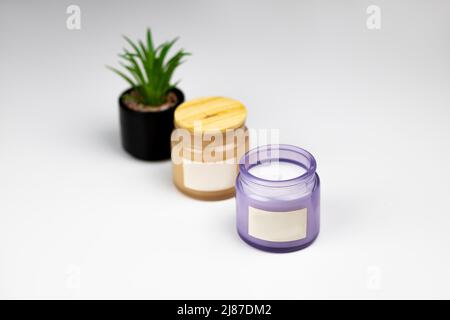 oil with rosemary and two candles with aroma peach and flower Stock Photo