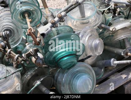 many glass insulators used in high voltage power lines to insulate electrical conductors and prevent electric shock Stock Photo