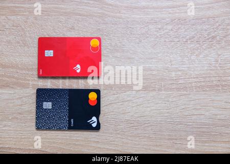 Castelo Branco, Portugal - May 13 2022:Top down shot of Santander credit and debit cards on wood counter Stock Photo