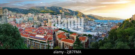 Scenic panorama of Monaco at sunrise. Beautiful view of the Monte Carlo and La Condamine quarters with seaport and yachts, surrounding mountains and t Stock Photo