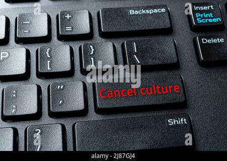 Cancel culture enter key on the black pc keyboard. Concepts of ostracism and call-out culture in the Internet and on social media. Computer enter key. Stock Photo