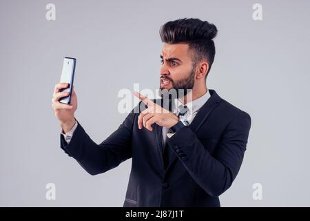 young handsome black hair man in stylish business suit in studio isolate white background video online chat social distance Stock Photo