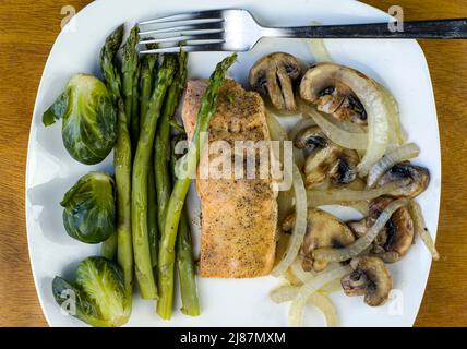 baked season salmon with sauteed onions and mushrooms Stock Photo