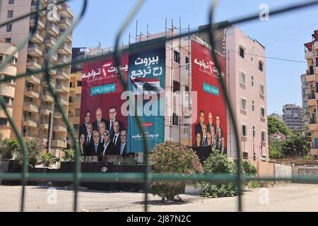 Beirut, Lebanon. 13th May, 2022. Huge posters of candidates for the Lebanese parliamentary elections are seen in Beirut, Lebanon, on May 13, 2022. The Lebanese minister of defense announced Friday that the army will be deployed across the country on the parliament elections day on Sunday to help keep voting safe. Credit: Liu Zongya/Xinhua/Alamy Live News Stock Photo