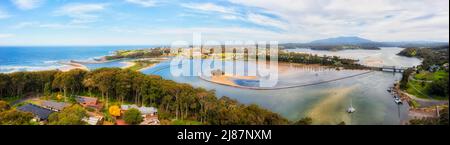 Aerial panorama over Narooma town river inlet on the South Coast of NSW, Australia - aquaculture oyster fishing farms. Stock Photo