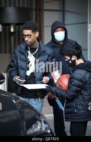 Rapper PnB Rock signs an autograph for a fan before he enters the