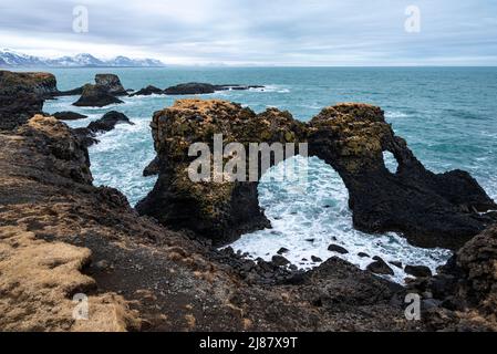 Scenic view of the Gatklettur rock arch in late winter, at the black basalt cliffs of Arnarstapi on the south coast of the Snæfellsnes, Iceland Stock Photo