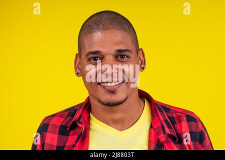 arabic brazilian man posing at studio in yellow background Stock Photo