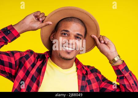 arabic brazilian man posing at studio in yellow background Stock Photo