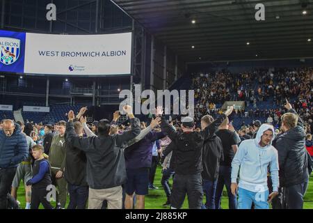 West Bromwich, UK. 13th May, 2022. West Bromwich Albion fans celebrate their teams win in front of the Wolverhampton Wanderers fans in West Bromwich, United Kingdom on 5/13/2022. (Photo by Gareth Evans/News Images/Sipa USA) Credit: Sipa USA/Alamy Live News Stock Photo