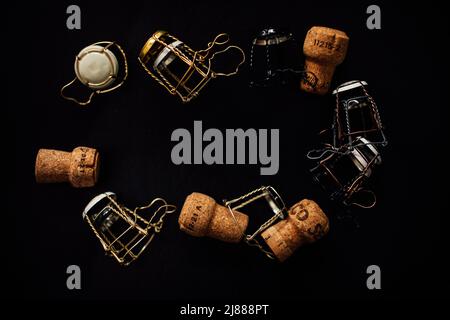 a collection of assorted champagne cages and corks arranged in a circle, oval with copy space in the center Stock Photo