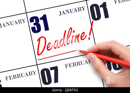 31st day of January. Hand drawing red line and writing the text Deadline on calendar date January 31. Deadline word written on calendar Winter month, Stock Photo