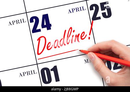 24th day of April.  Hand drawing red line and writing the text Deadline on calendar date April 24. Deadline word written on calendar Spring month, day Stock Photo