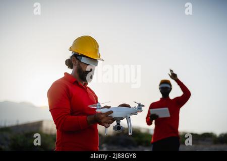Drone engineer working with futuristic glasses on construction site - Aerial engineering concept Stock Photo