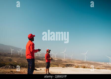 Drone engineers working with futuristic glasses on construction site - Aerial engineering concept Stock Photo