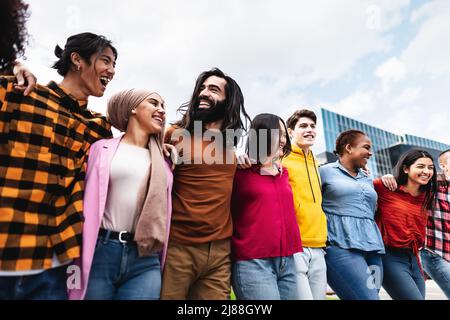 Young multiracial friends having fun together hanging out in the city - Friendship and diversity concept Stock Photo