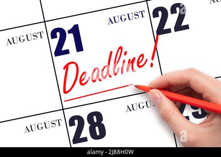 21st day of August. Hand drawing red line and writing the text Deadline on calendar date August 21. Deadline word written on calendar Summer month, da Stock Photo