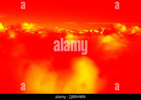 Colored clouds. Cloudscape under the wing of an airplane. Illustration of thermal image Stock Photo