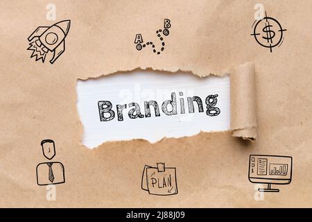 The concept of development and creation of branding. Icons and inscription on paper Stock Photo