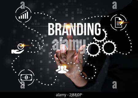 The concept of development and creation of branding. Hand and abstract business icons Stock Photo