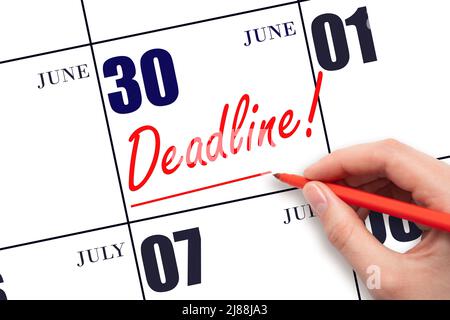 30th day of June. Hand drawing red line and writing the text Deadline on calendar date June 30. Deadline word written on calendar Summer month, day of Stock Photo