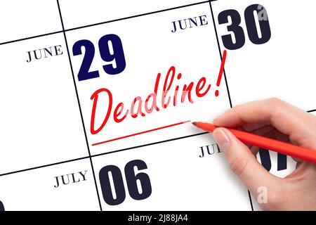29th day of June. Hand drawing red line and writing the text Deadline on calendar date June 29. Deadline word written on calendar Summer month, day of Stock Photo