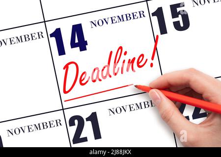 14th day of November. Hand drawing red line and writing the text Deadline on calendar date November 14. Deadline word written on calendar Autumn month Stock Photo