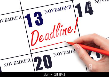 13th day of November. Hand drawing red line and writing the text Deadline on calendar date November 13. Deadline word written on calendar Autumn month Stock Photo