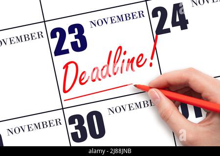 23rd day of November. Hand drawing red line and writing the text Deadline on calendar date November 23. Deadline word written on calendar Autumn month Stock Photo