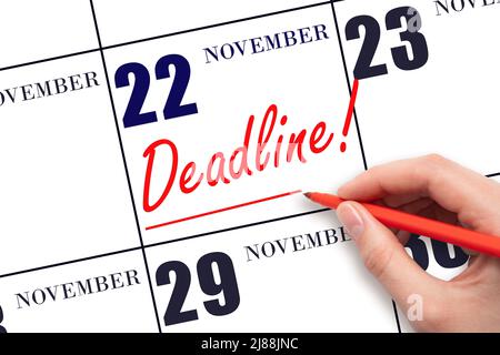 22nd day of November. Hand drawing red line and writing the text Deadline on calendar date November 22. Deadline word written on calendar Autumn month Stock Photo