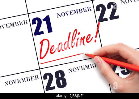 21st day of November. Hand drawing red line and writing the text Deadline on calendar date November 21. Deadline word written on calendar Autumn month Stock Photo