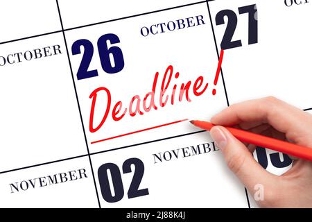 26th day of October. Hand drawing red line and writing the text Deadline on calendar date October 26. Deadline word written on calendar Autumn month, Stock Photo