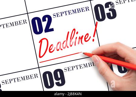 2nd day of September. Hand drawing red line and writing the text Deadline on calendar date September  2. Deadline word written on calendar Autumn mont Stock Photo
