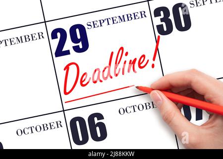 29th day of September. Hand drawing red line and writing the text Deadline on calendar date September  29. Deadline word written on calendar Autumn mo Stock Photo