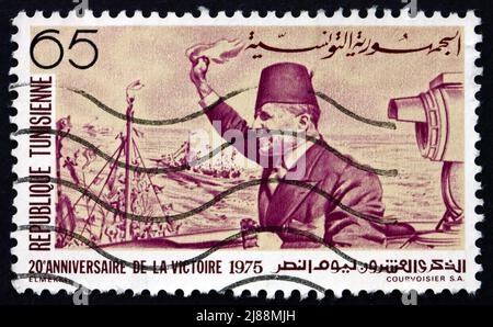 TUNISIA - CIRCA 1975: a stamp printed in Tunisia shows Habib Bourguiba Arriving at La Goulette, Tunis, 20th Anniversary of Independence, circa 1975 Stock Photo