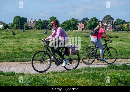 London UK, 14 May 2022.  Cyclist riding on Wimbledon Common south west London as  temperatures for most of Britain are expected to climb to a possible high of 27C today which  will see the hottest day of the year so far Credit. amer ghazzal/Alamy Live News Stock Photo