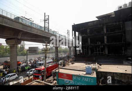 New Delhi, India. 14th May, 2022. View of a destroyed three-story commercial building near Mundka Metro Station in New Delhi. A massive fire broke out at a building near west Delhiís Mundka Metro Station on Friday evening, leaving 27 people dead and 12 injured, the police said. Credit: SOPA Images Limited/Alamy Live News Stock Photo