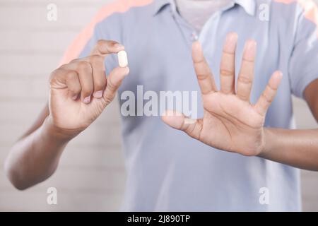 upset man hand holding medical pills  Stock Photo