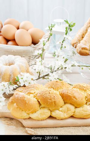 Loaf of sweet bread and cherry blossom twig in the background Stock Photo