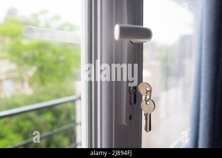 keys on the balcony door. Safety for child at home. Closing door at apartment Stock Photo