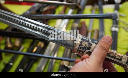 Kinzhal  is a dagger, often with a single off-set groove on each face of the blade. With engraving on the blade Stock Photo