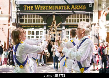 Morris dancers perform in Westminster, central London. Temperatures are warming up for the weekend as most of Britain can expect to be bathed in sunshine. However, the Met Office warned that a sun-kissed Saturday, which would be ideal for a barbecue, could be followed by heavy rain and thunderstorms. Picture date: Saturday May 14, 2022. Stock Photo