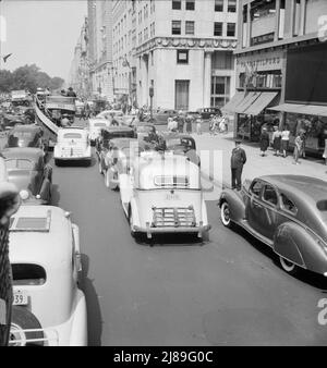 Traffic on Fifth Avenue approaching 57th Street on a summer afternoon. New York City. Stock Photo