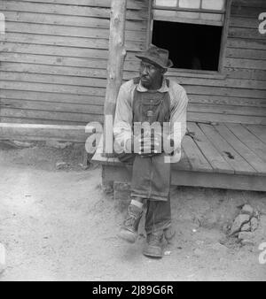 https://l450v.alamy.com/450v/2j89g6r/father-of-sharecropper-family-he-is-sixty-nine-years-old-has-six-acres-of-tobacco-has-a-large-family-heard-in-conversation-on-his-porch-quotland-is-like-folks-it-gets-tired-and-needs-a-restquot-person-county-north-carolina-2j89g6r.jpg